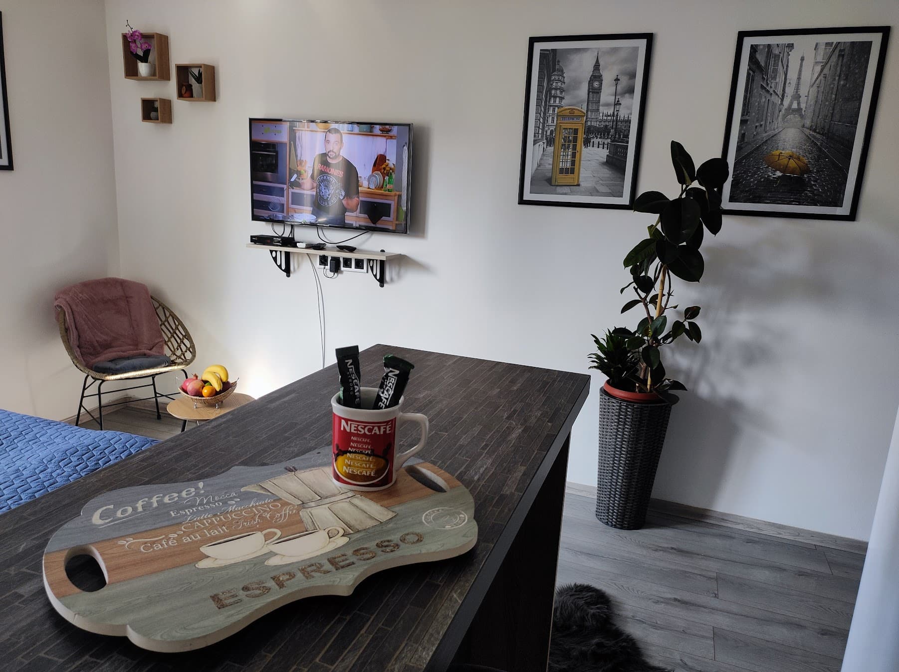 Seating area with TV and framed city prints